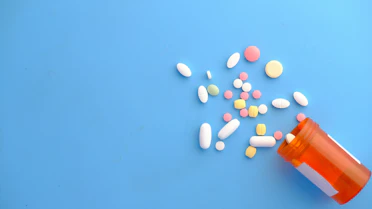 Generic pills and tablets on blue background